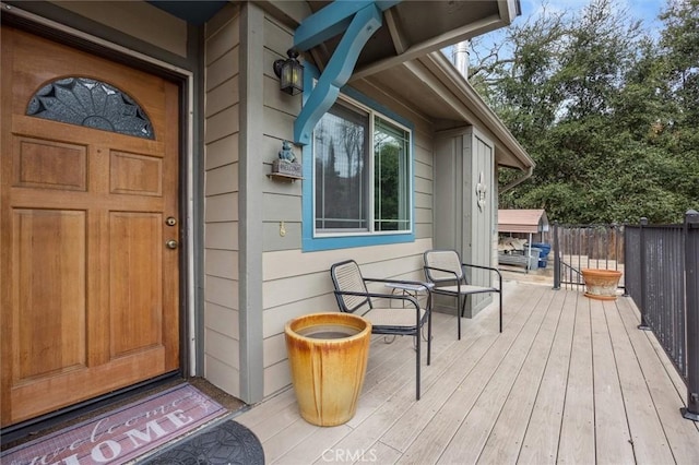 view of exterior entry featuring fence