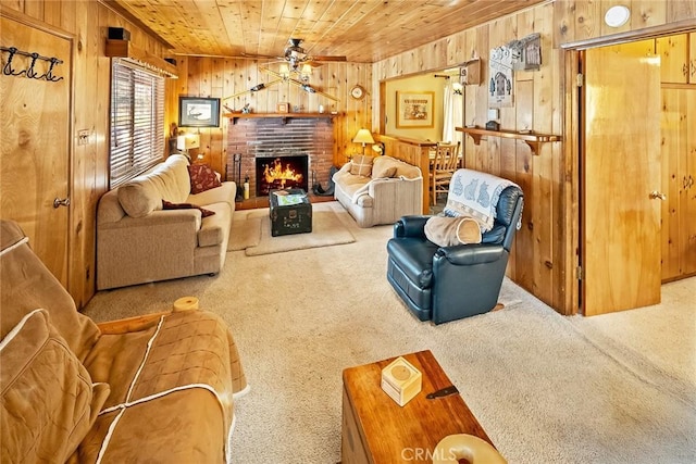 living room featuring carpet flooring, wood ceiling, wood walls, and ceiling fan