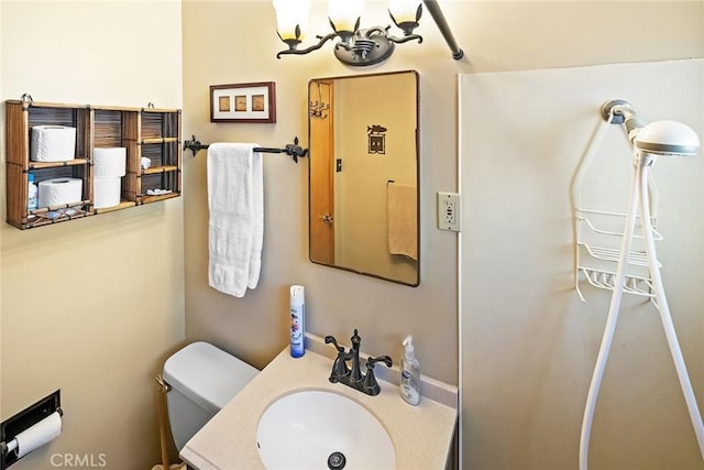 bathroom featuring toilet and vanity