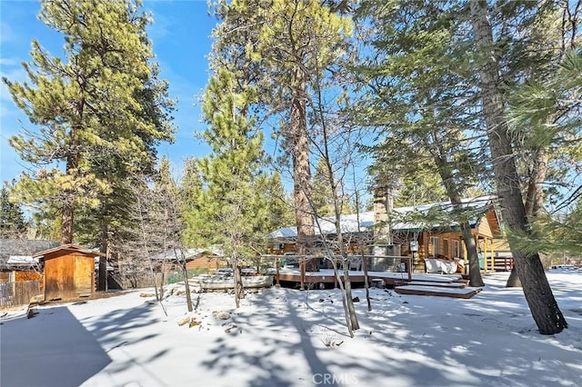 snowy yard with a wooden deck