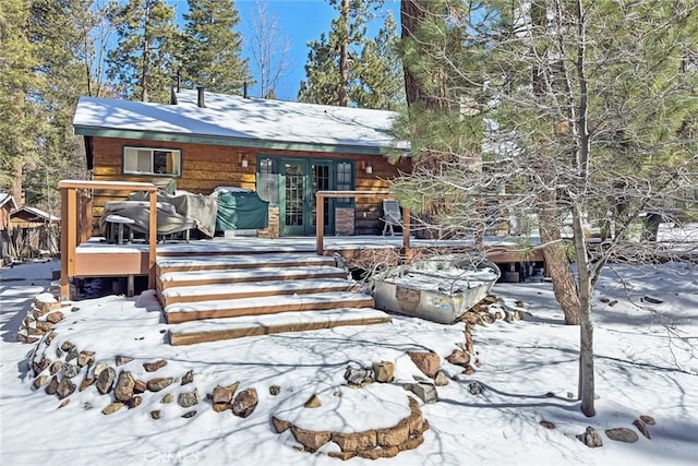 snow covered house with a deck