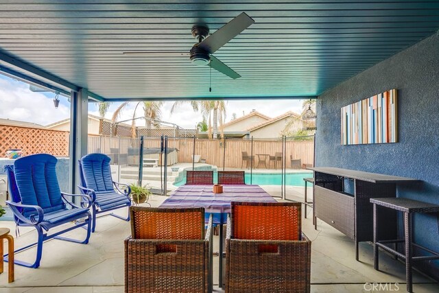 view of patio with a ceiling fan, outdoor dining space, a fenced backyard, and a fenced in pool