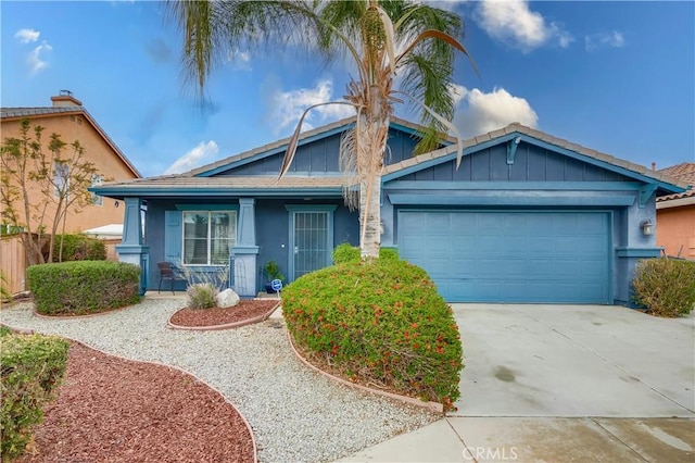 view of front of home with stucco siding, concrete driveway, and an attached garage