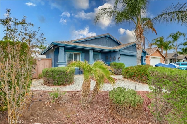 view of front of property with a garage and fence