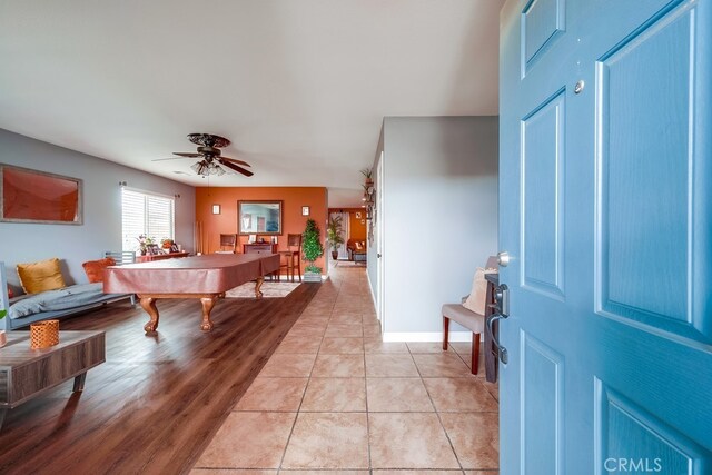 foyer with light tile patterned floors, baseboards, a ceiling fan, and billiards