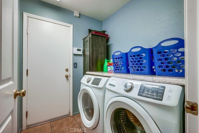 laundry area featuring tile patterned floors, laundry area, and separate washer and dryer