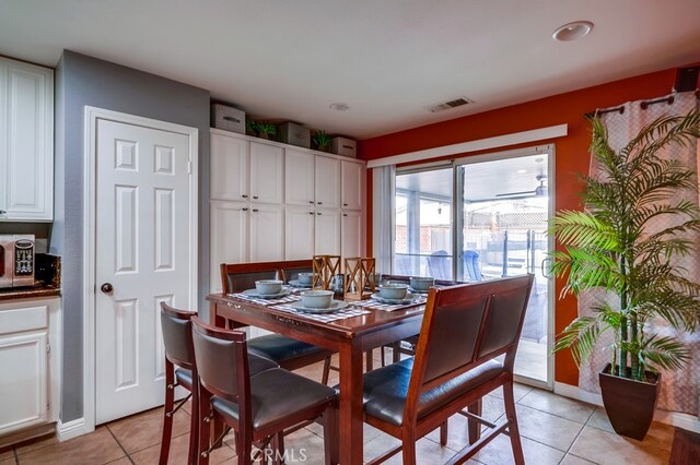 dining area with light tile patterned floors, baseboards, and visible vents
