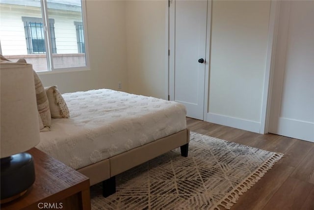 bedroom with wood finished floors and baseboards