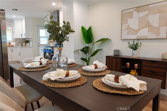 dining room with visible vents, recessed lighting, and light wood-style floors