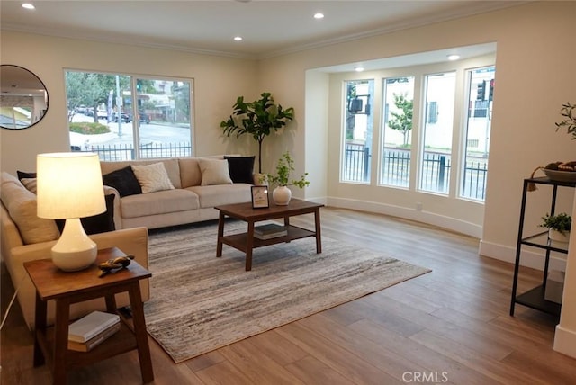 living room with recessed lighting, baseboards, wood finished floors, and ornamental molding