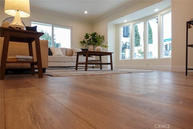 interior space featuring crown molding, wood finished floors, recessed lighting, and baseboards