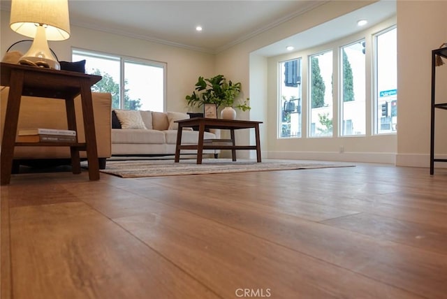 sitting room featuring baseboards, crown molding, and recessed lighting