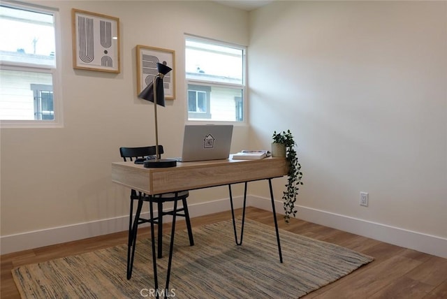 office area featuring baseboards and wood finished floors