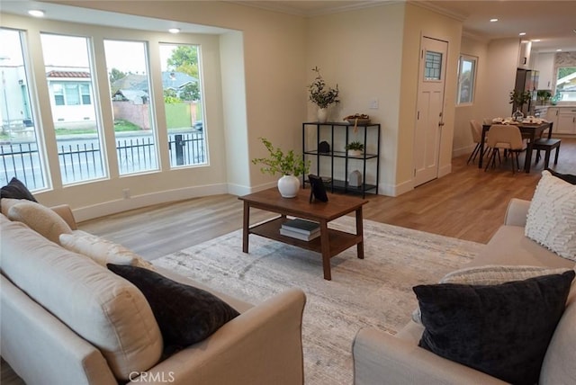 living area with a healthy amount of sunlight, light wood-style floors, and recessed lighting