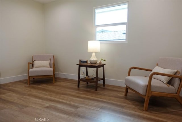 sitting room featuring light wood-type flooring and baseboards