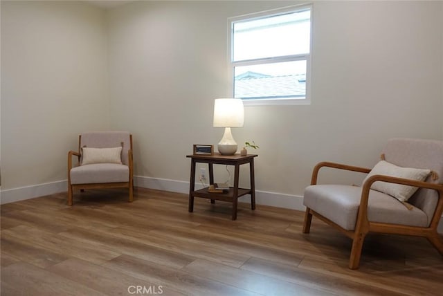 living area with baseboards and light wood-style floors