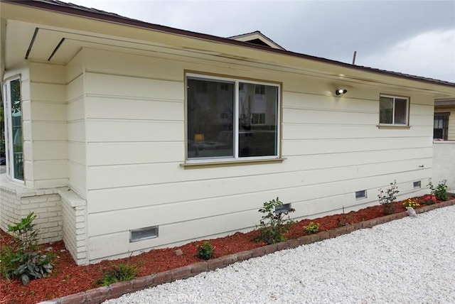 view of side of home with crawl space