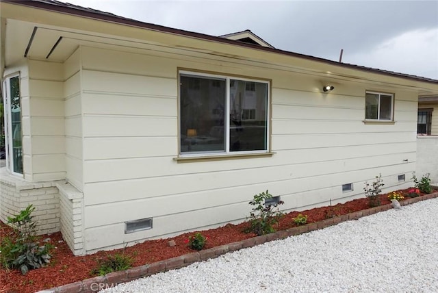 view of side of home featuring crawl space