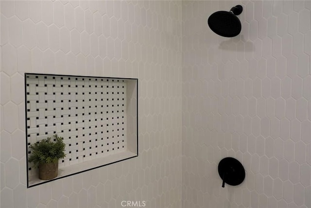 interior details featuring a tile shower