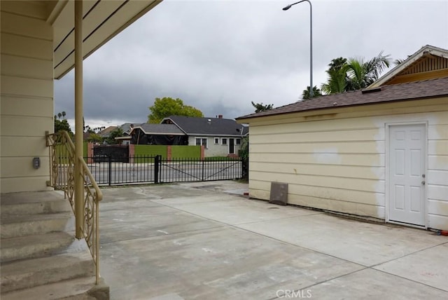 view of patio with fence and a gate