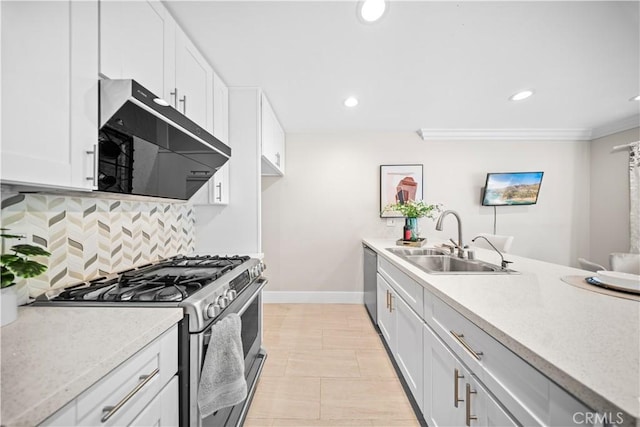 kitchen featuring a sink, tasteful backsplash, range hood, stainless steel appliances, and white cabinets