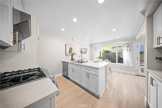 kitchen with light countertops, ornamental molding, stainless steel appliances, and a sink