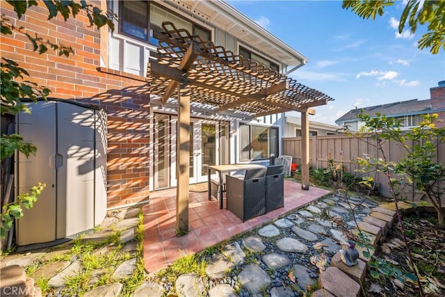 view of patio featuring a pergola and fence