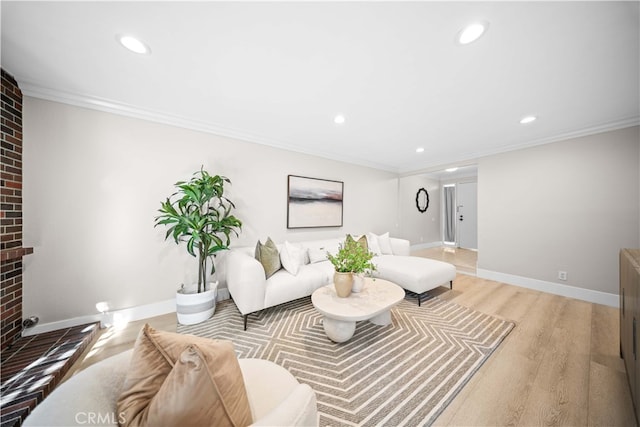 living room with baseboards, light wood-style floors, a brick fireplace, and ornamental molding