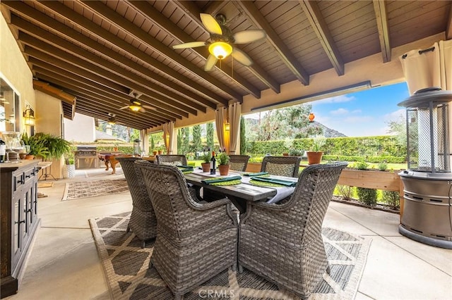 view of patio / terrace featuring ceiling fan, outdoor dining area, and an outdoor kitchen