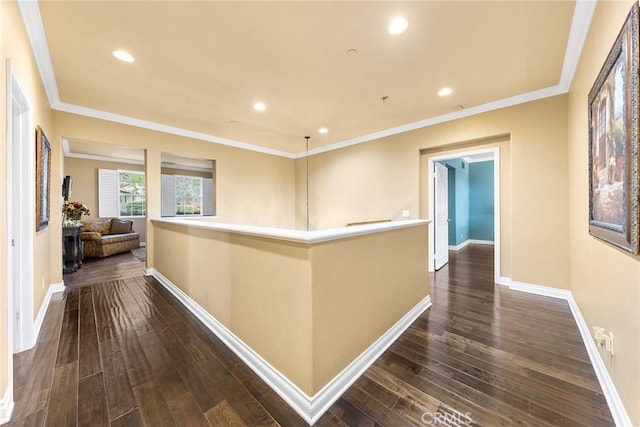 hallway with recessed lighting, dark wood-style floors, baseboards, and ornamental molding