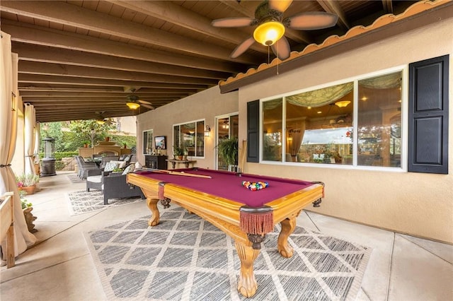 playroom featuring pool table, beam ceiling, concrete flooring, and ceiling fan