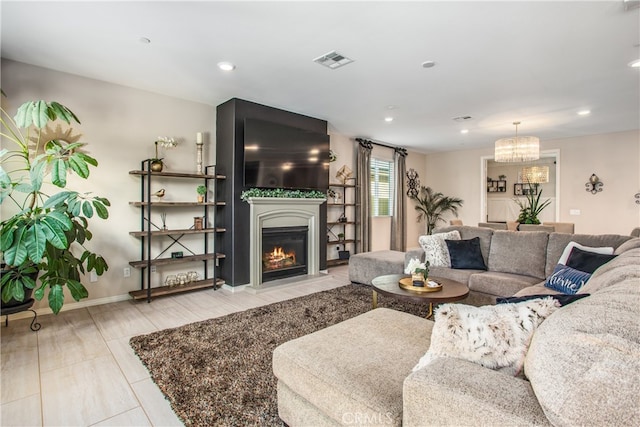 living room featuring a fireplace with flush hearth, recessed lighting, an inviting chandelier, visible vents, and baseboards