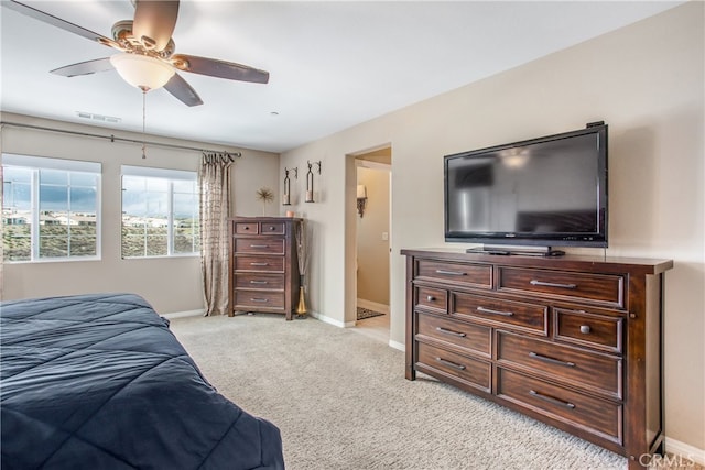 bedroom with ceiling fan, baseboards, visible vents, and light carpet
