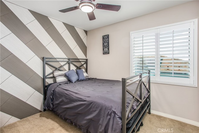 carpeted bedroom with baseboards and ceiling fan