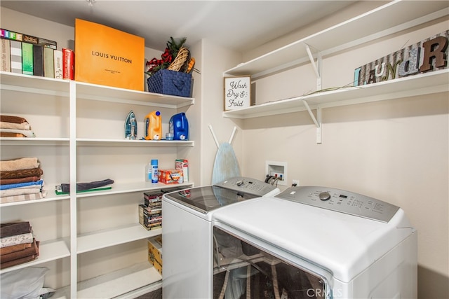 clothes washing area with washer and clothes dryer and laundry area