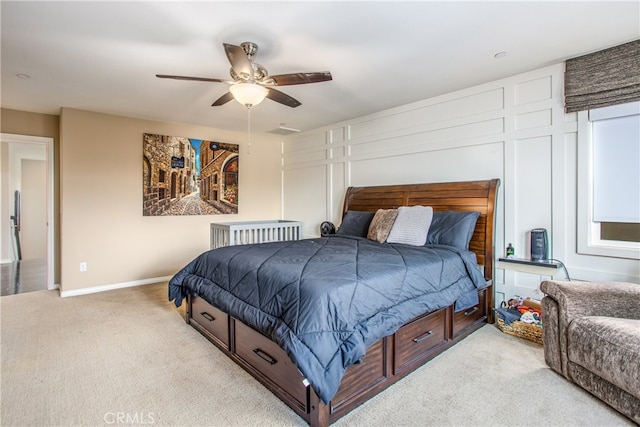 bedroom featuring light carpet, baseboards, and ceiling fan