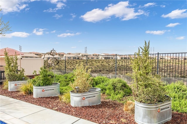 view of yard featuring fence and a residential view