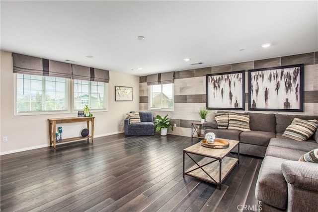 living area featuring recessed lighting, visible vents, baseboards, and dark wood-style flooring