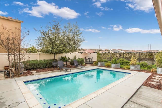view of swimming pool with a patio area, a fenced backyard, and a fenced in pool