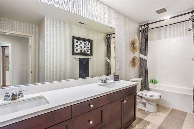 bathroom featuring wallpapered walls, visible vents, a sink, and toilet