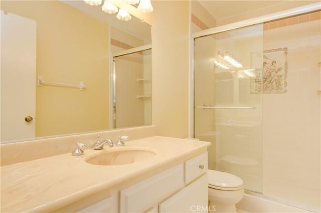 full bath featuring a stall shower, toilet, and vanity