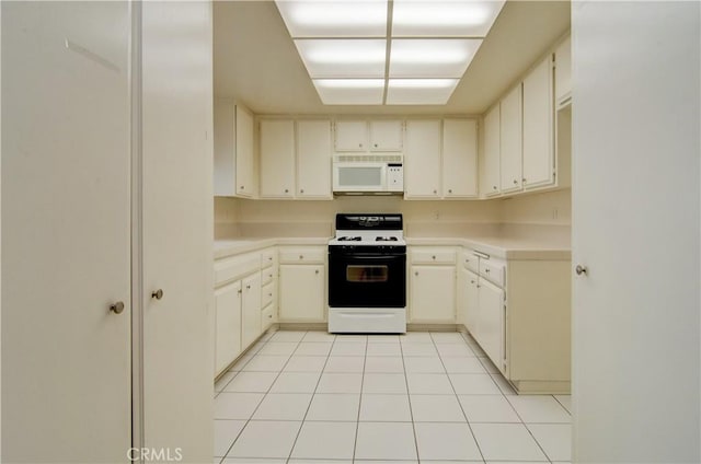 kitchen with light tile patterned floors, white appliances, and light countertops