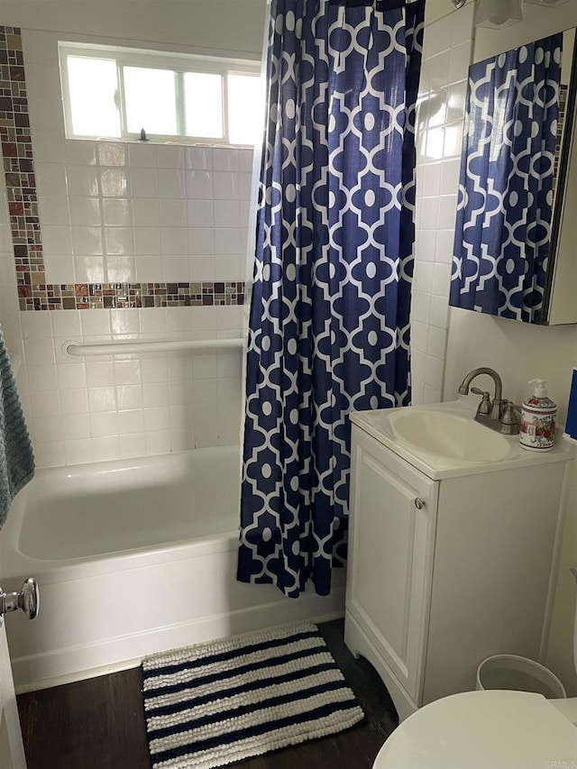 bathroom featuring vanity, shower / bath combination with curtain, and toilet