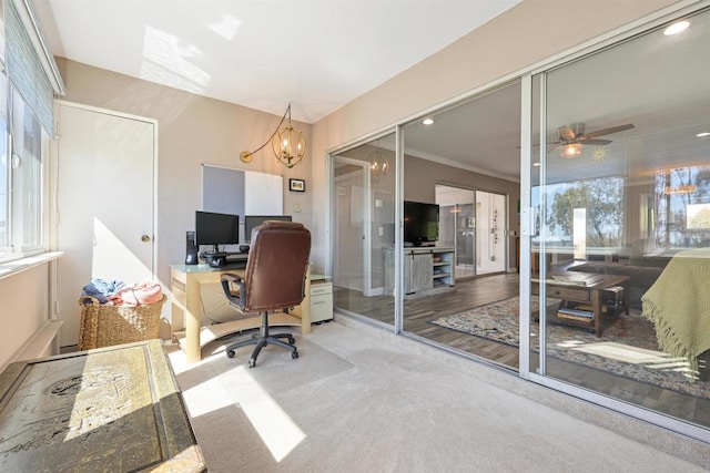 carpeted home office featuring ceiling fan with notable chandelier, crown molding, and recessed lighting