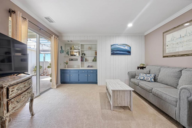 living area featuring crown molding, built in features, visible vents, and light carpet