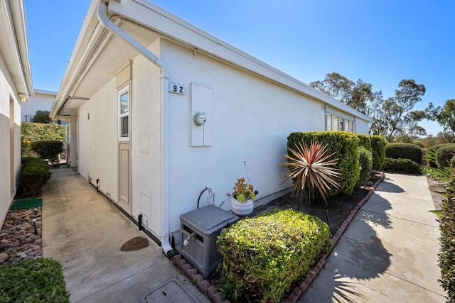 view of side of property with stucco siding