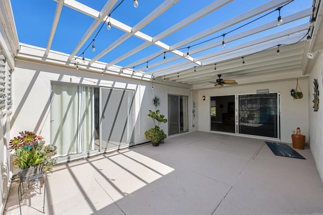 view of patio / terrace with glass enclosure, a pergola, and ceiling fan