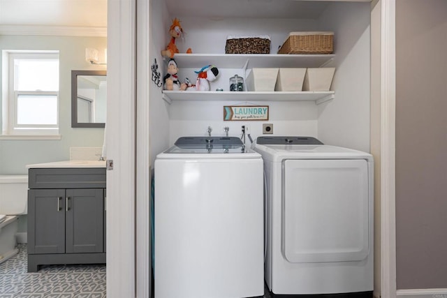 laundry area featuring washer and dryer, laundry area, and ornamental molding