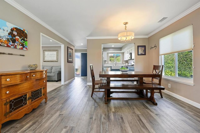 dining room with visible vents, baseboards, and wood finished floors