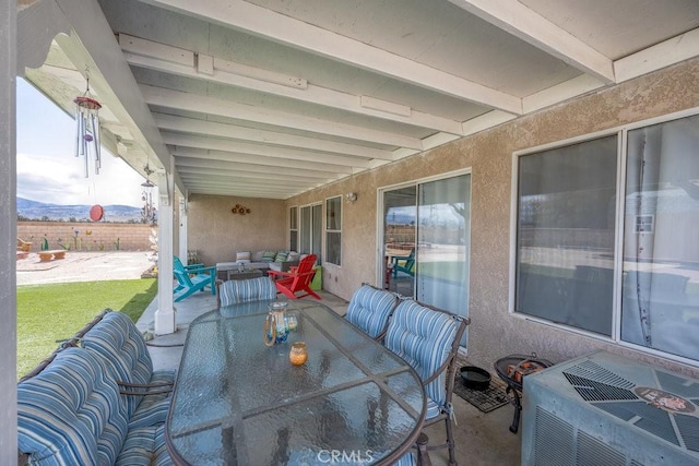 view of patio / terrace with a mountain view, outdoor dining space, and outdoor lounge area